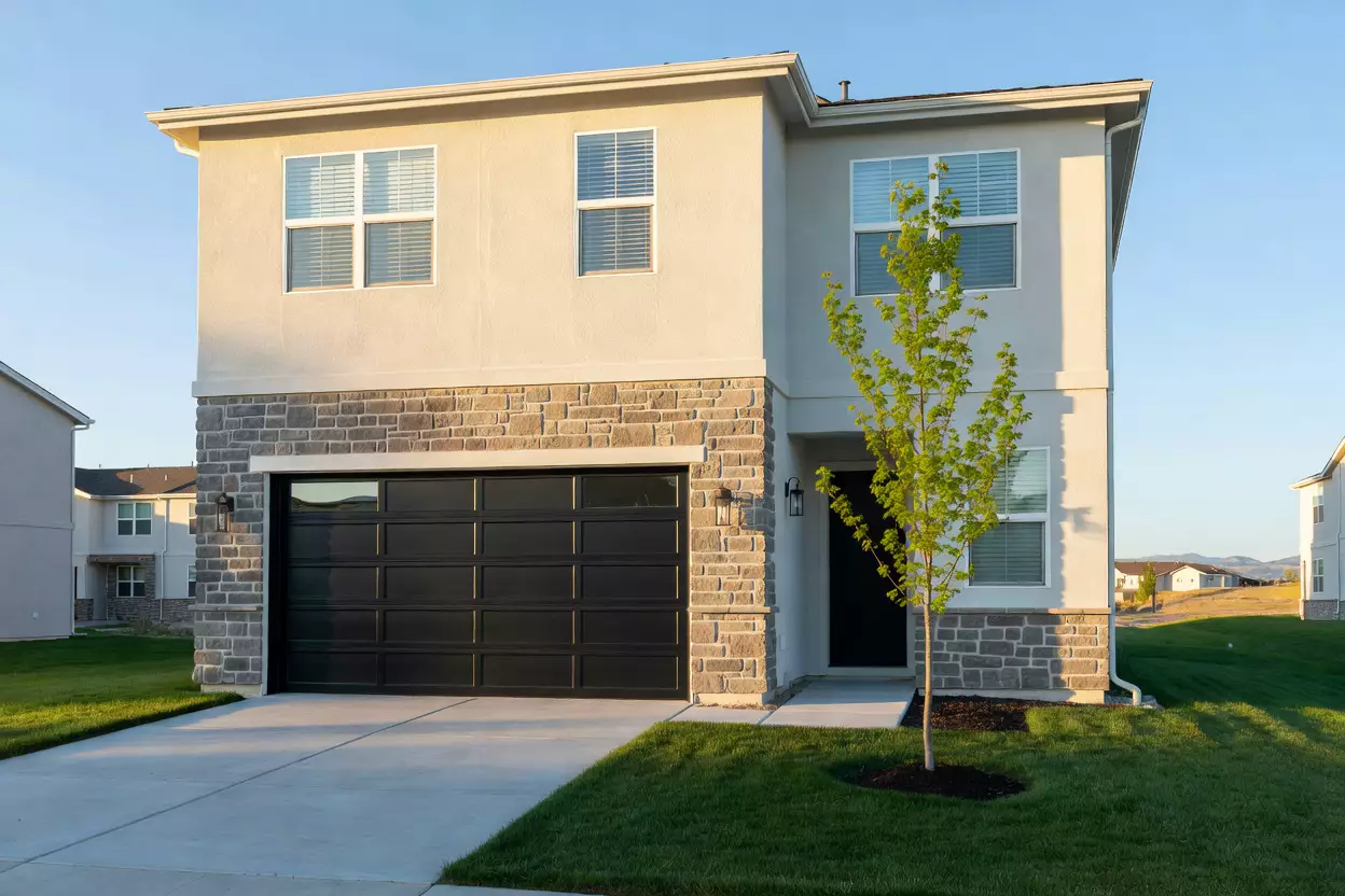 Cream townhome with a stone entry on Copper Lantern Lane