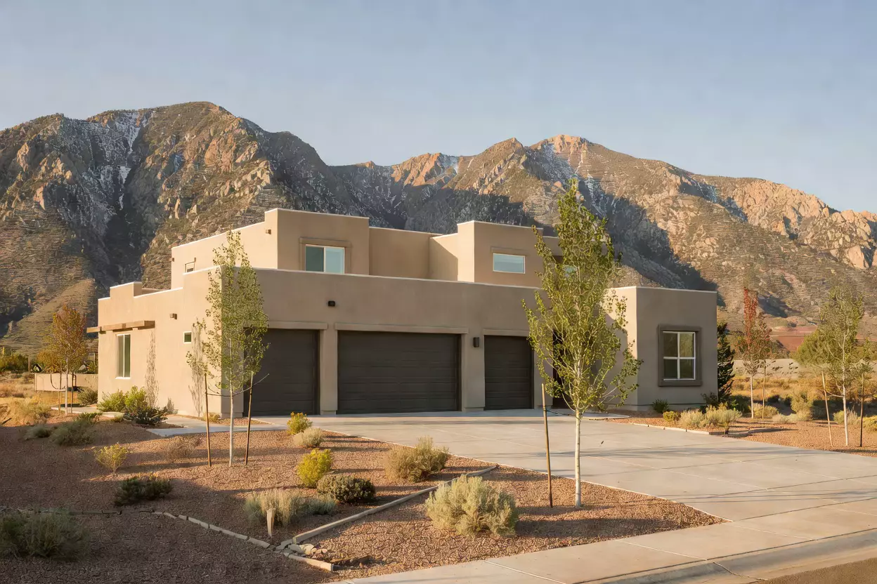 Newer beige stucco house with the mountains behind