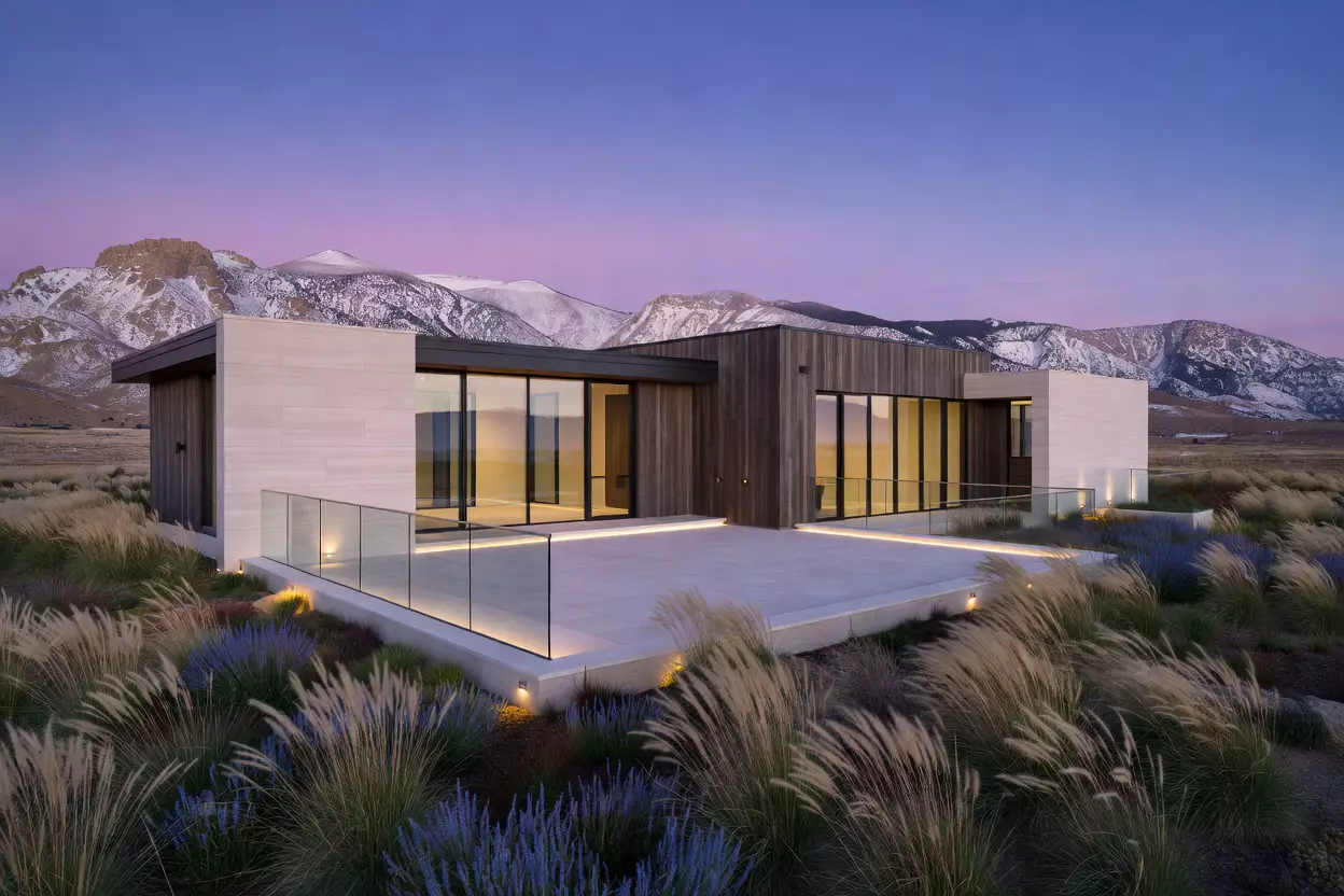 Contemporary glass and stone estate at dusk
